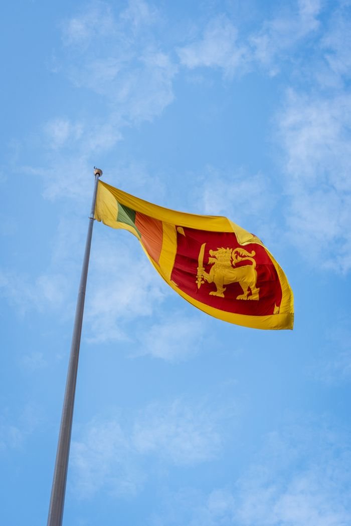 Flag of Sri Lanka waving proudly against a clear blue sky in Colombo.