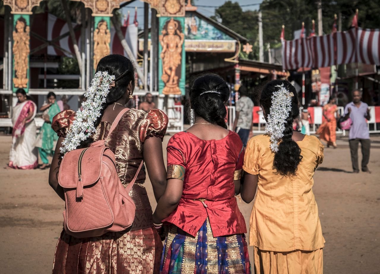Women in vibrant traditional attire at a festive gathering in Jaffna, Sri Lanka.