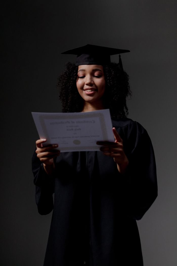 Crafting Captivating Headlines: Your awesome post title goes here Young woman in cap and gown celebrating graduation moment indoors.